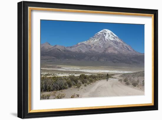 A Man Cycles in the Shadow of Sajama Volcano in Sajama National Park-Alex Saberi-Framed Photographic Print