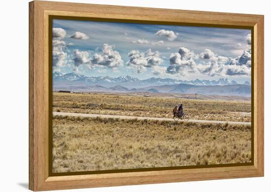 A Man Cycles with a Family Member on the Back of His Bicycle Between La Paz and Tiwanaku-Alex Saberi-Framed Premier Image Canvas