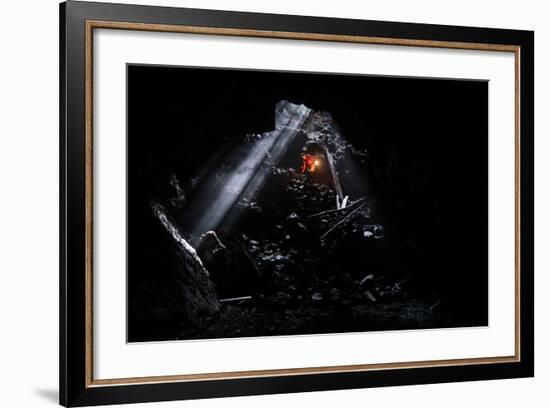 A Man Holding A Propane Lantern Exits The Cheese Cave, A 2,000 Foot Lava Tube-Ben Herndon-Framed Photographic Print