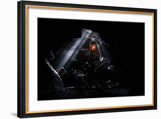 A Man Holding A Propane Lantern Exits The Cheese Cave, A 2,000 Foot Lava Tube-Ben Herndon-Framed Photographic Print