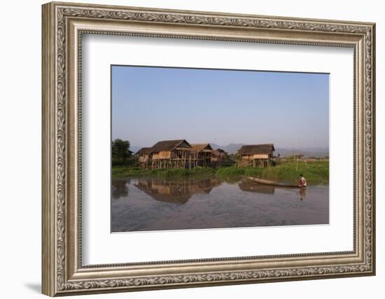 A man paddles his canoe past one of the floating villages on Inle Lake, Myanmar (Burma), Asia-Alex Treadway-Framed Photographic Print