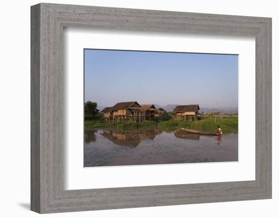 A man paddles his canoe past one of the floating villages on Inle Lake, Myanmar (Burma), Asia-Alex Treadway-Framed Photographic Print