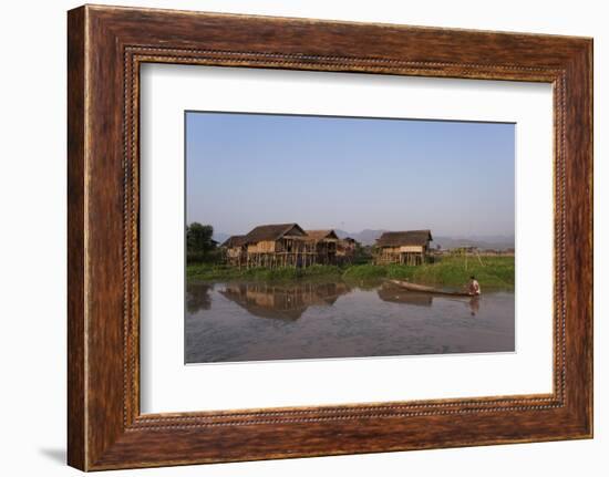 A man paddles his canoe past one of the floating villages on Inle Lake, Myanmar (Burma), Asia-Alex Treadway-Framed Photographic Print