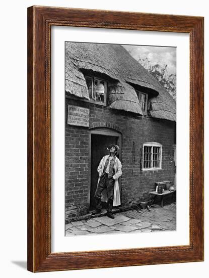 A Man Smoking a Pipe Outside a Shop, Worcestershire, C1922-AW Cutler-Framed Giclee Print