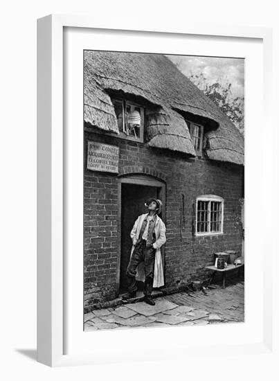 A Man Smoking a Pipe Outside a Shop, Worcestershire, C1922-AW Cutler-Framed Giclee Print