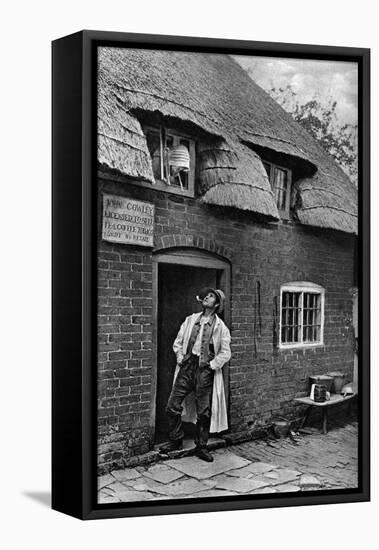 A Man Smoking a Pipe Outside a Shop, Worcestershire, C1922-AW Cutler-Framed Premier Image Canvas
