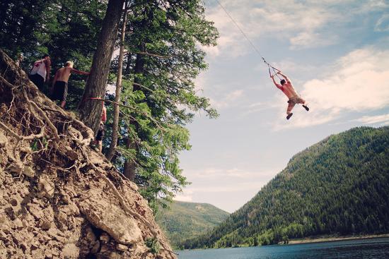 A Man Swings From A Rope Swing Into A Lake At Smith And Morehouse Reservoir Utah Photographic Print By Lindsay Daniels Art Com
