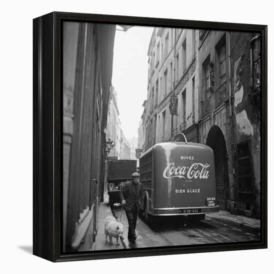 A Man Walks His Dog Beside a Bus with Coca Cola Advertisement, France, 1950-Mark Kauffman-Framed Premier Image Canvas