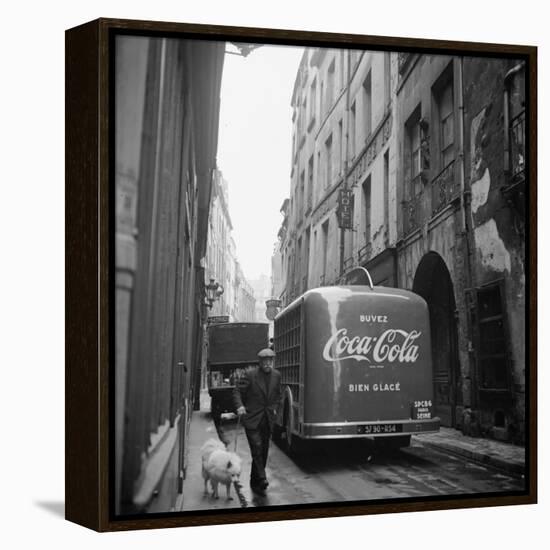 A Man Walks His Dog Beside a Bus with Coca Cola Advertisement, France, 1950-Mark Kauffman-Framed Premier Image Canvas