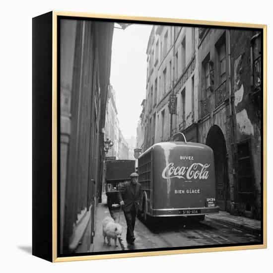 A Man Walks His Dog Beside a Bus with Coca Cola Advertisement, France, 1950-Mark Kauffman-Framed Premier Image Canvas