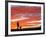 A Man Walks His Dog Under a Red Sky-null-Framed Photographic Print