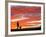 A Man Walks His Dog Under a Red Sky-null-Framed Photographic Print