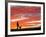 A Man Walks His Dog Under a Red Sky-null-Framed Photographic Print