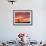 A Man Walks His Dog Under a Red Sky-null-Framed Photographic Print displayed on a wall
