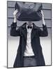 A Man Wearing a Bow Tie Hiding Behind a Bag-India Hobson-Mounted Photographic Print