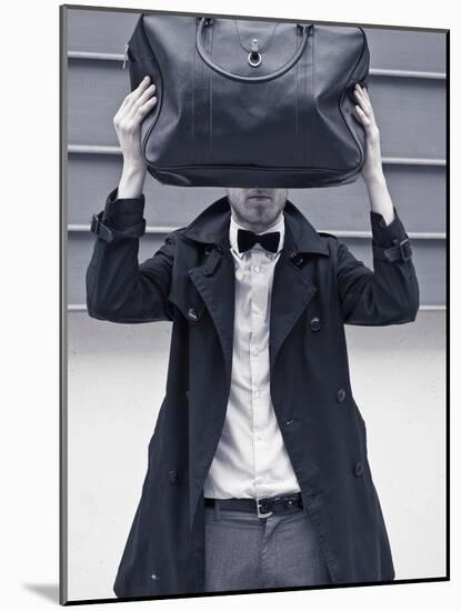 A Man Wearing a Bow Tie Hiding Behind a Bag-India Hobson-Mounted Photographic Print