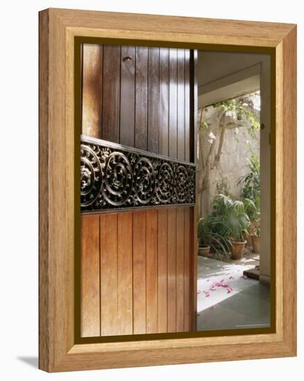 A Modern Front Door Decorated with a 400 Year Old Piece of Wood Carving-John Henry Claude Wilson-Framed Premier Image Canvas