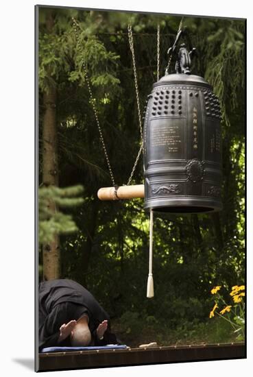 A Monk Making a Prostration under the Big Temple Bell, Zen Temple Ryumonji, Weiterswiller, France-null-Mounted Photographic Print