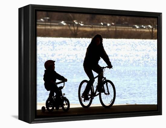 A Mother and Son are Silhouetted as They Ride Along the Schuylkill River-null-Framed Premier Image Canvas