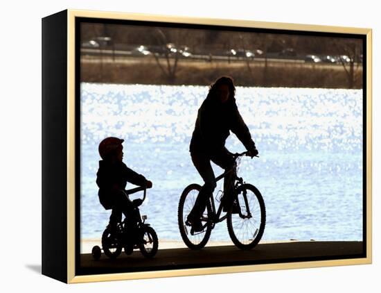 A Mother and Son are Silhouetted as They Ride Along the Schuylkill River-null-Framed Premier Image Canvas