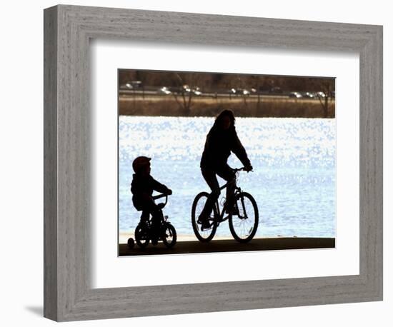 A Mother and Son are Silhouetted as They Ride Along the Schuylkill River-null-Framed Photographic Print