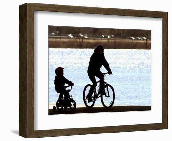 A Mother and Son are Silhouetted as They Ride Along the Schuylkill River-null-Framed Photographic Print