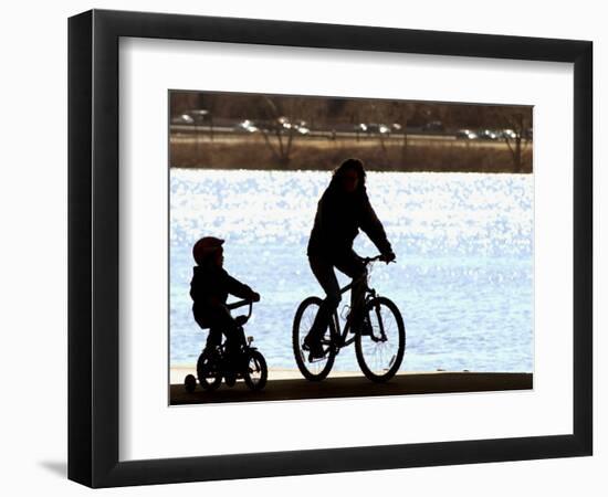 A Mother and Son are Silhouetted as They Ride Along the Schuylkill River-null-Framed Photographic Print