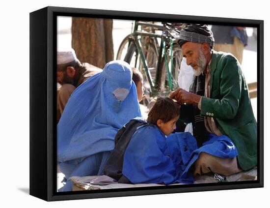 A Mother Watches as Her Child Gets a Haircut in the Center of Kabul, Afghanistan on Oct. 9, 2003.-null-Framed Premier Image Canvas