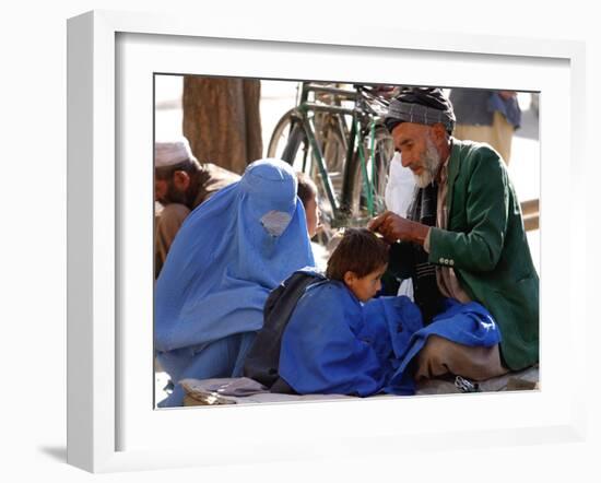 A Mother Watches as Her Child Gets a Haircut in the Center of Kabul, Afghanistan on Oct. 9, 2003.-null-Framed Photographic Print