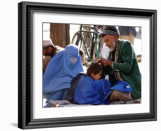 A Mother Watches as Her Child Gets a Haircut in the Center of Kabul, Afghanistan on Oct. 9, 2003.-null-Framed Photographic Print