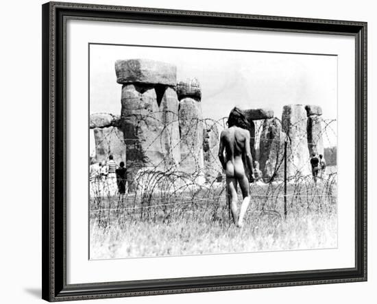 A Naked Hippy Watches Stonehenge from Behind Barb Wire on Summer Solstice-null-Framed Photographic Print