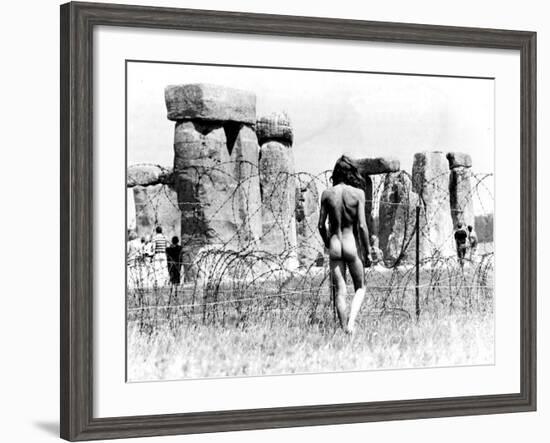 A Naked Hippy Watches Stonehenge from Behind Barb Wire on Summer Solstice-null-Framed Photographic Print