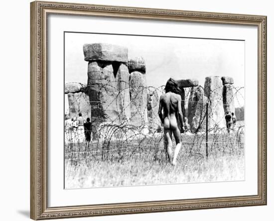 A Naked Hippy Watches Stonehenge from Behind Barb Wire on Summer Solstice-null-Framed Photographic Print