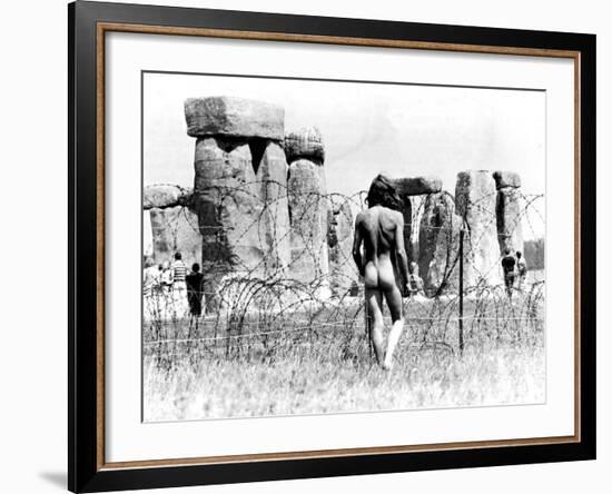 A Naked Hippy Watches Stonehenge from Behind Barb Wire on Summer Solstice--Framed Photographic Print