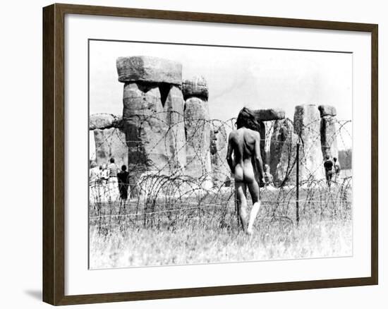 A Naked Hippy Watches Stonehenge from Behind Barb Wire on Summer Solstice-null-Framed Photographic Print