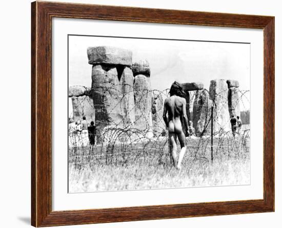 A Naked Hippy Watches Stonehenge from Behind Barb Wire on Summer Solstice-null-Framed Photographic Print