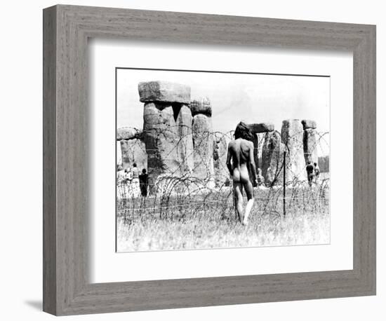 A Naked Hippy Watches Stonehenge from Behind Barb Wire on Summer Solstice-null-Framed Photographic Print