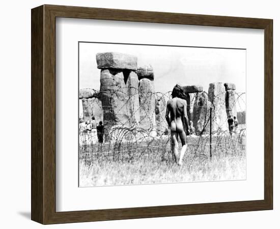 A Naked Hippy Watches Stonehenge from Behind Barb Wire on Summer Solstice-null-Framed Photographic Print