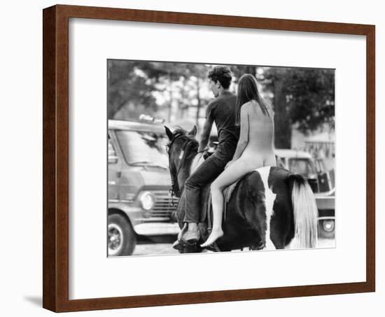 A Naked Young Women and Escort Ride a Horse Through Goose Lake Park at 3 Day Rock Music Festival-null-Framed Photo