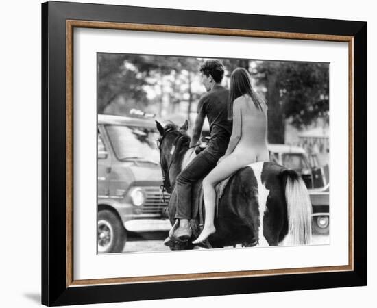 A Naked Young Women and Escort Ride a Horse Through Goose Lake Park at 3 Day Rock Music Festival-null-Framed Photo