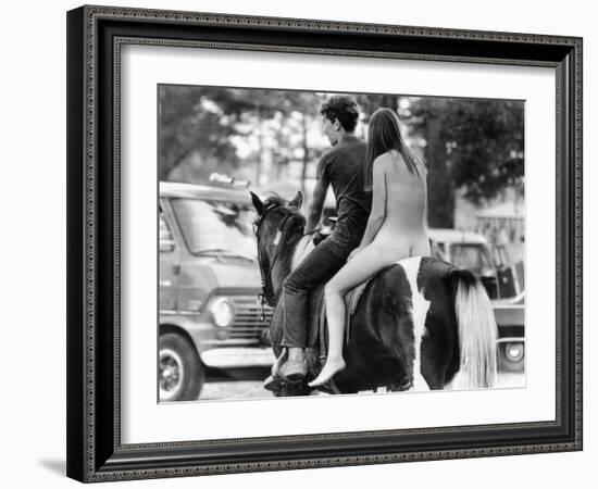 A Naked Young Women and Escort Ride a Horse Through Goose Lake Park at 3 Day Rock Music Festival-null-Framed Photo