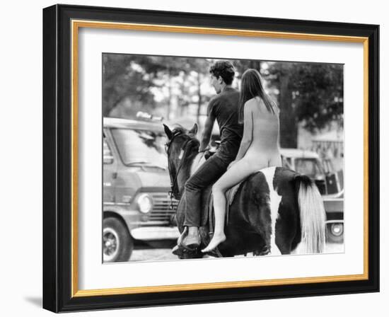 A Naked Young Women and Escort Ride a Horse Through Goose Lake Park at 3 Day Rock Music Festival-null-Framed Photo