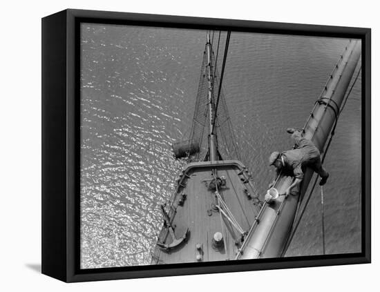 A Painter Lays Across the Rigging While Painting on Sailing Ship-null-Framed Premier Image Canvas