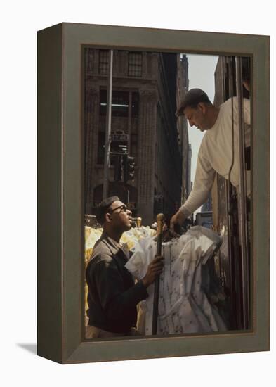 A Pair of Push Boys Unload Racks of Dresses on 7th Avenue, New York, New York, 1960-Walter Sanders-Framed Premier Image Canvas