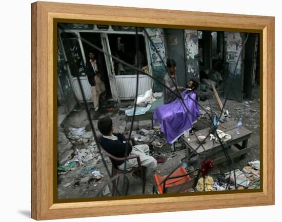 A Pakistani Barber Gives a Haircut and Beard Trim to a Customer-null-Framed Premier Image Canvas