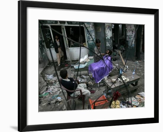 A Pakistani Barber Gives a Haircut and Beard Trim to a Customer-null-Framed Photographic Print