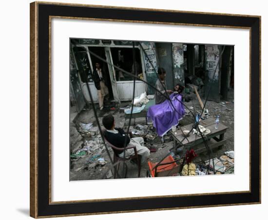 A Pakistani Barber Gives a Haircut and Beard Trim to a Customer-null-Framed Photographic Print