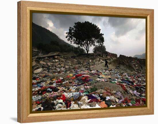 A Pakistani Refugee Walks Past Clothing Left Strewn on the Ground-null-Framed Premier Image Canvas