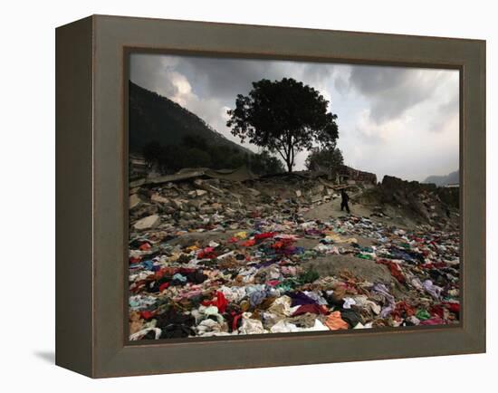 A Pakistani Refugee Walks Past Clothing Left Strewn on the Ground-null-Framed Premier Image Canvas