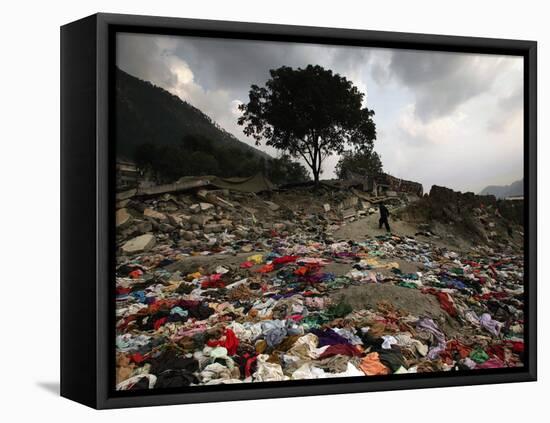 A Pakistani Refugee Walks Past Clothing Left Strewn on the Ground-null-Framed Premier Image Canvas